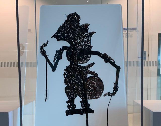 A black shadow puppet of a person on a white background