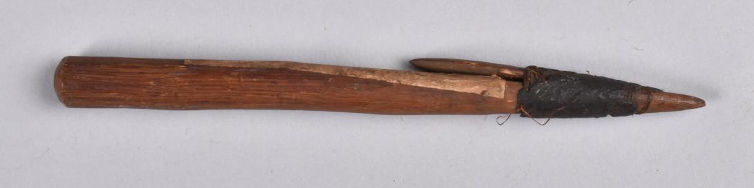 Spear-head made of wood with a single wooden barb attached to the shaft with fibre and resin.