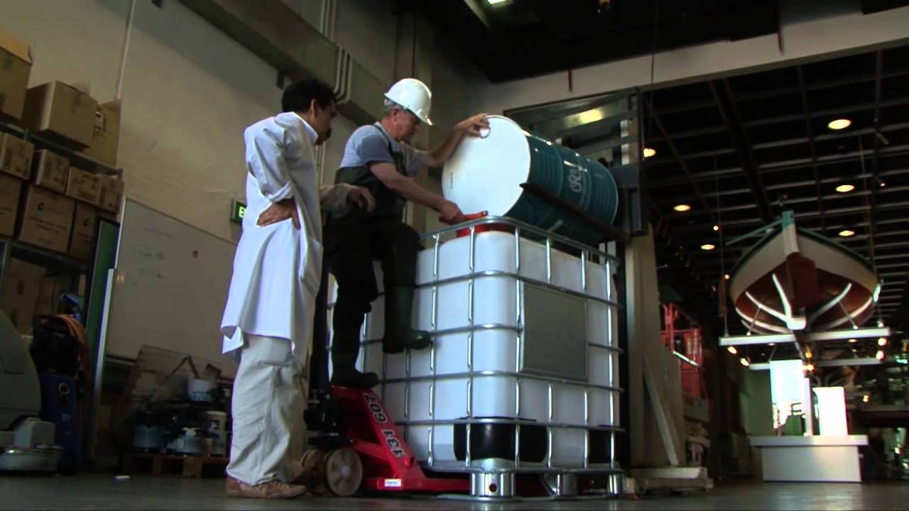 Museum staff shift a large white container in our loading bay.