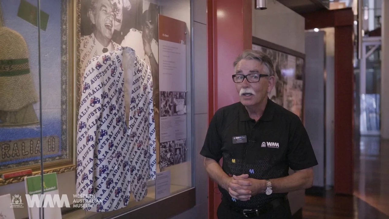 A friendly Museum staff member next to the famous Bob Hawke jacket.