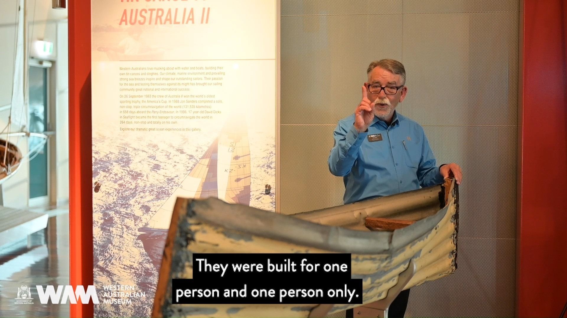 A friendly Museum staff member telling us about tin canoe, while standing next to it in the gallery.