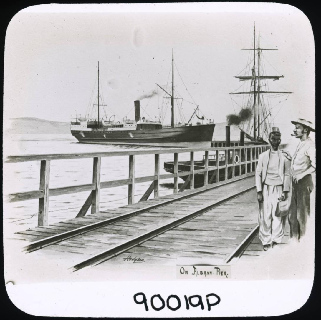 A drawing labelled "On Albany Pier." A dark-skinned and a light-skinned man stand together on a jetty. A ship is at the jetty and another is sailing in the distance.