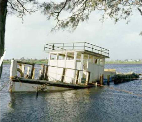 In this photo of the sunken boat, the bow and cabin are the only parts that are visible above water.