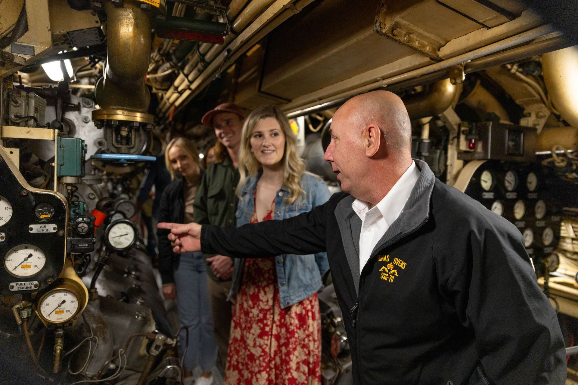 The Museum's volunteer guide points out some of the many dials used on the Ovens submarine.