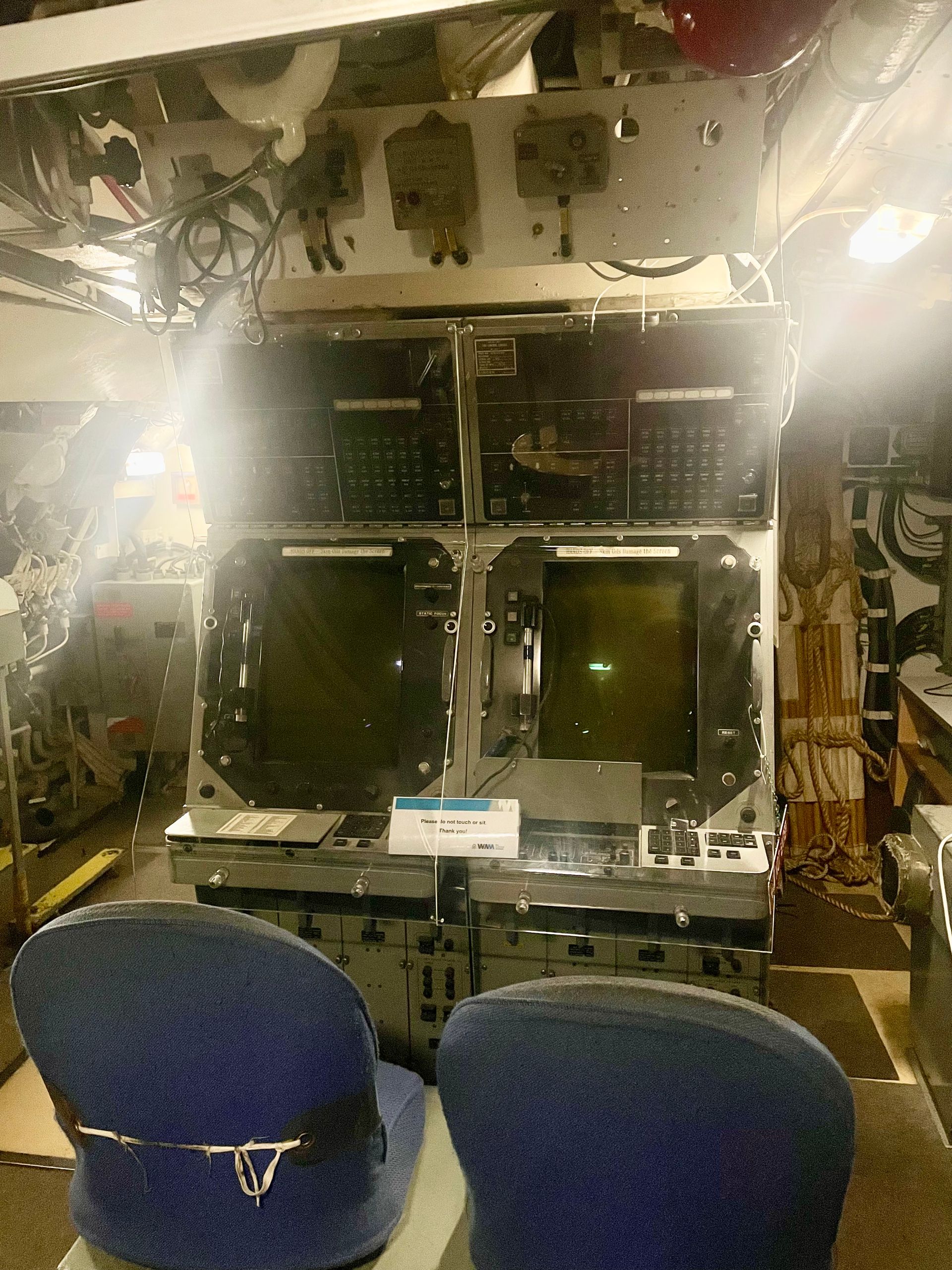Two large old glass tube computer screens with panels of many buttons.