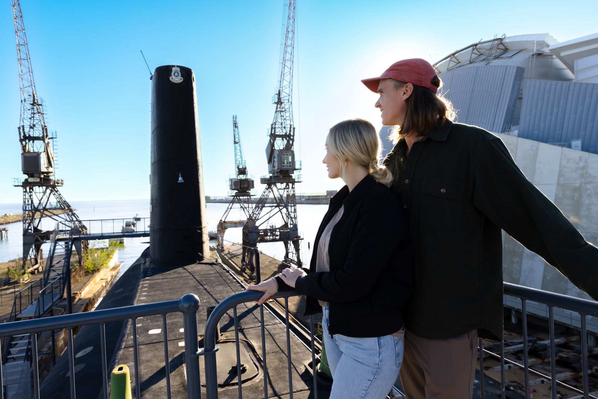 Two of the submarine tour group look out at the water from the top of the Ovens submarine.