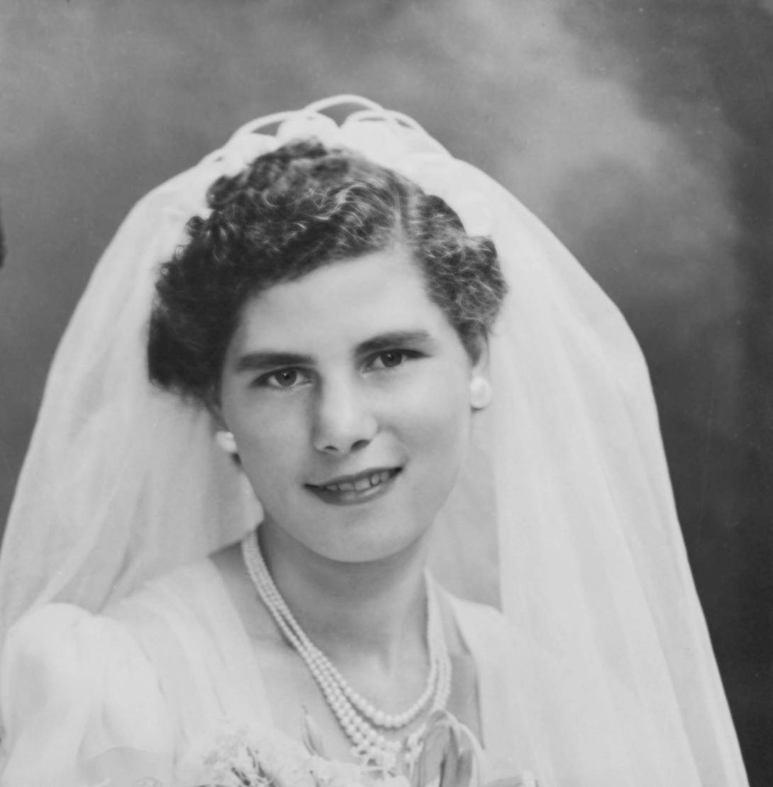 Professional studio portrait of Lena in wedding dress and veil.