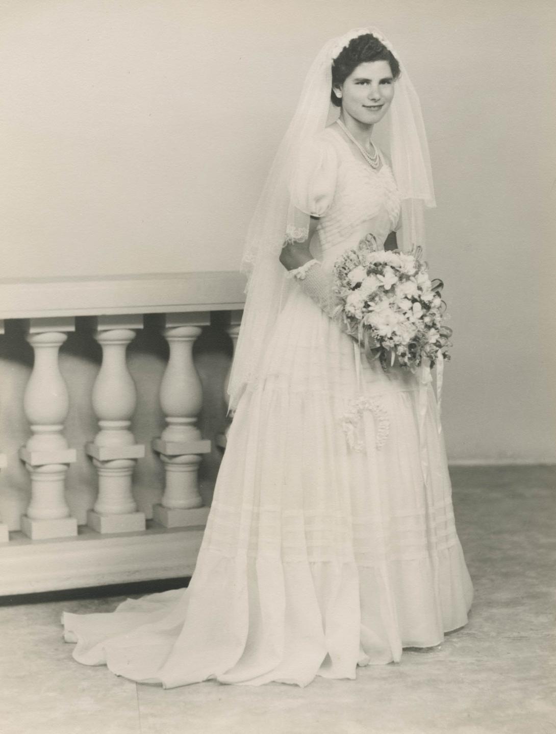 Full-length photo of Lena beside a staircase.
