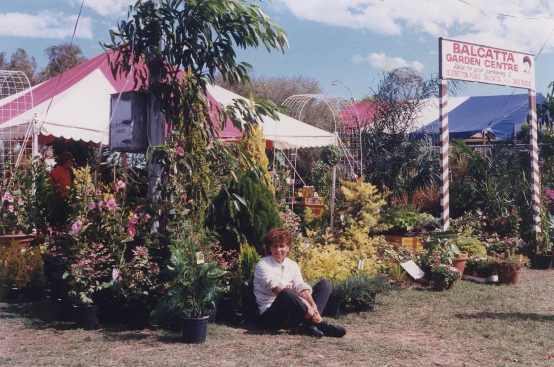 Lena sits cross-legged at the front of the Garden Centre.