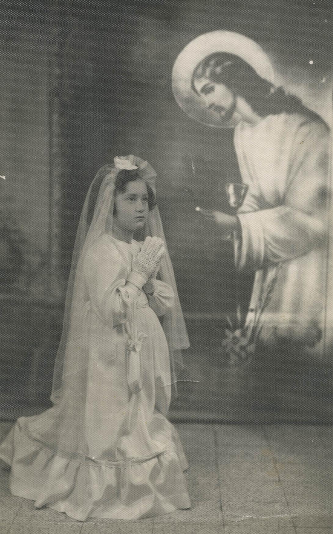 An old photo using a "special effect" to superimpose an image of Jesus next to a kneeling Giulia.