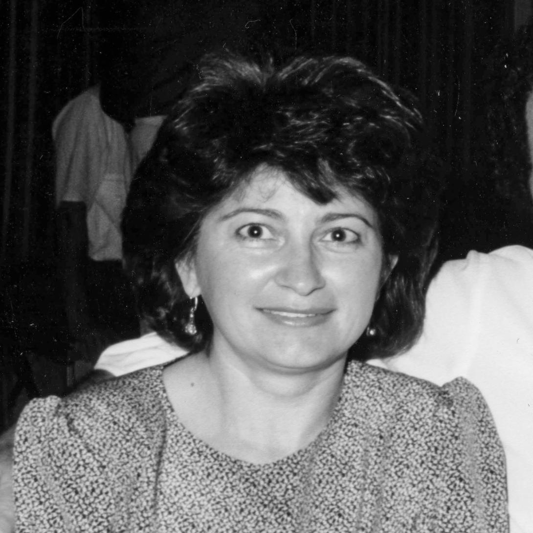 Black and white photo of Anna at a social gathering.