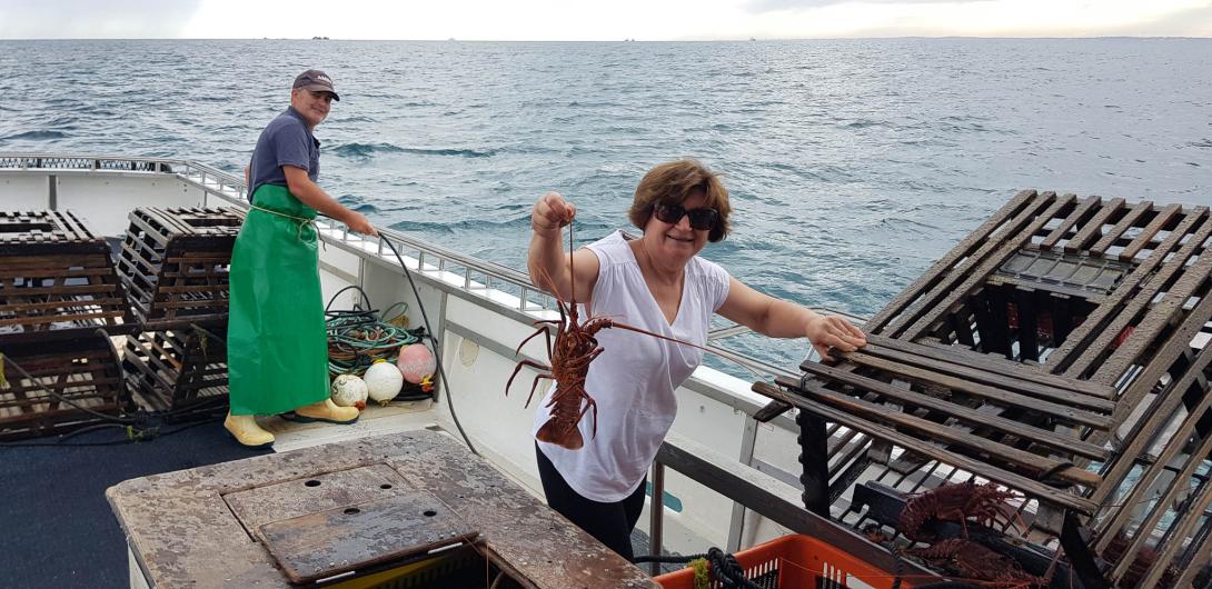 Anna holds up a large crayfish.