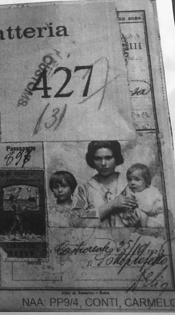 Section of a formal document picturing a woman with two children, signatures and prominent numbers 427