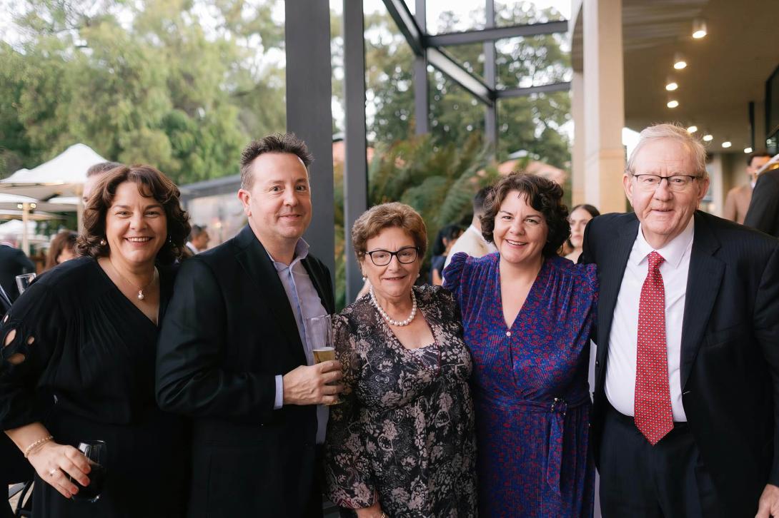 Present-day photo of the couple at an event with their adult children.