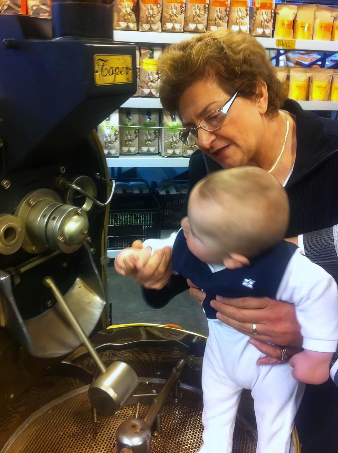 Anne holding a tiny baby up to the machine.
