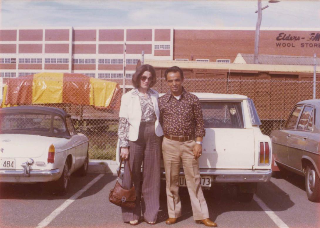 Adele and Angelo wearing wide-legged pants in front of the Elders Wool Stores building.