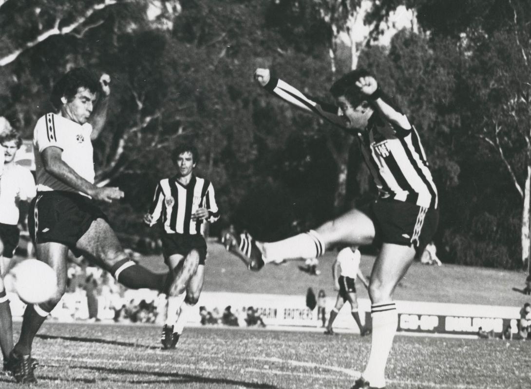 Action shot of Gary kicking a football.