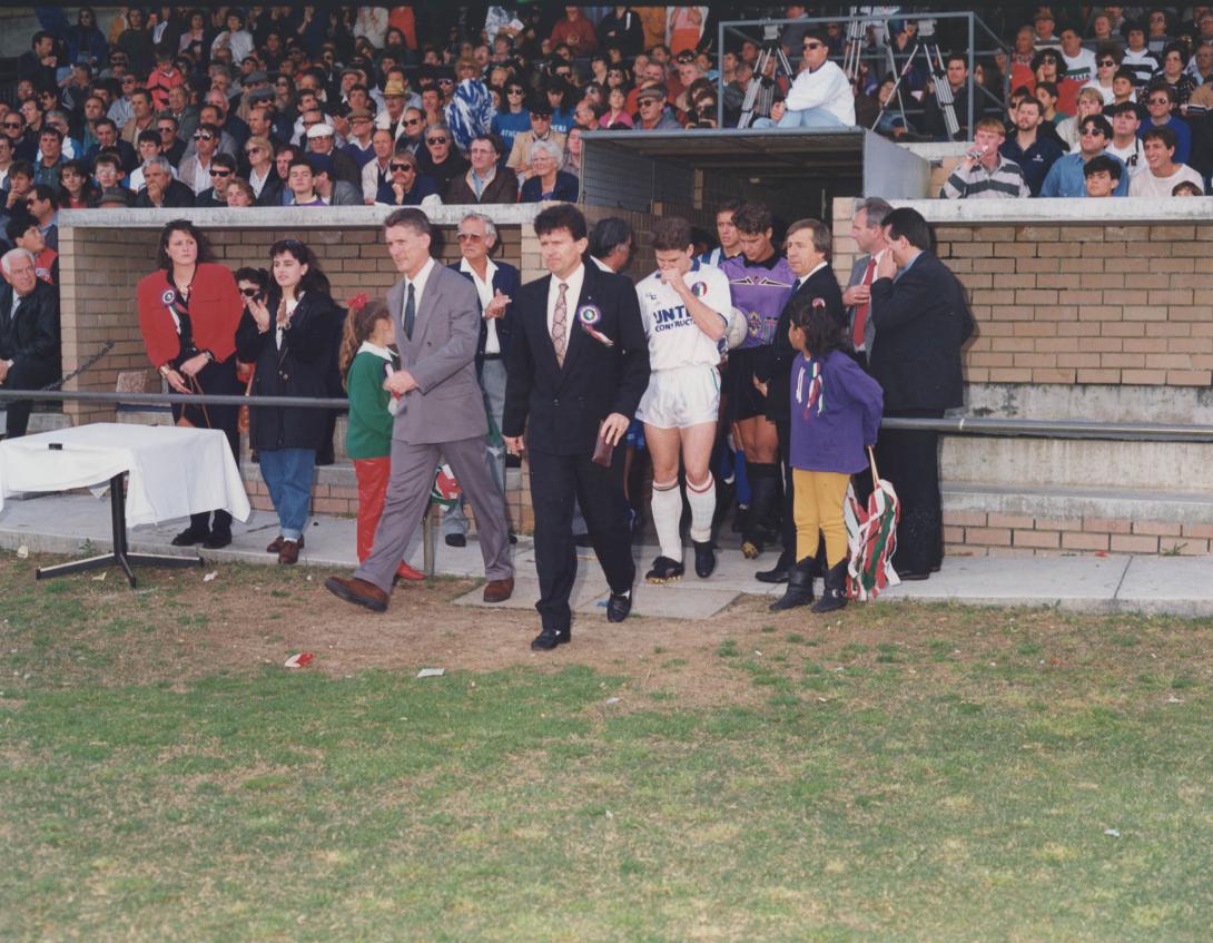 Gary and players emerging from the team's rooms onto the field.