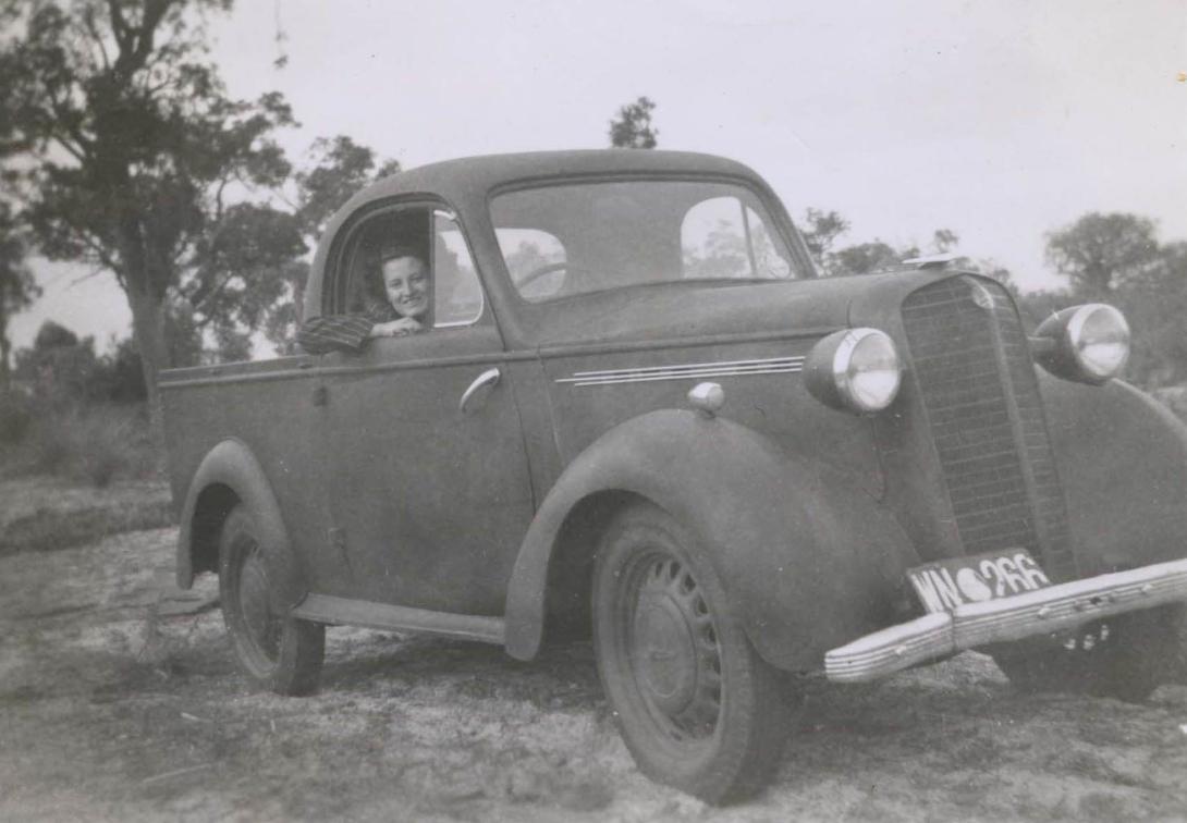 Doris smiling at the camera out the window of the old ute.