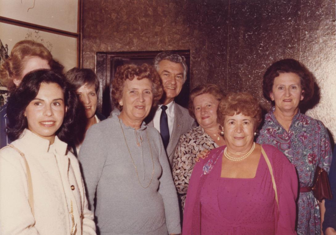 A group of women posing together, Hawke's head poking out from the back.