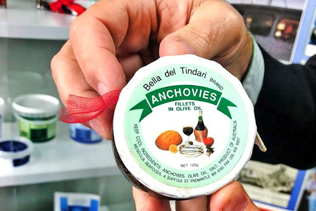 Close-up of a jar lid labelled "Anchovies fillets in olive oil."