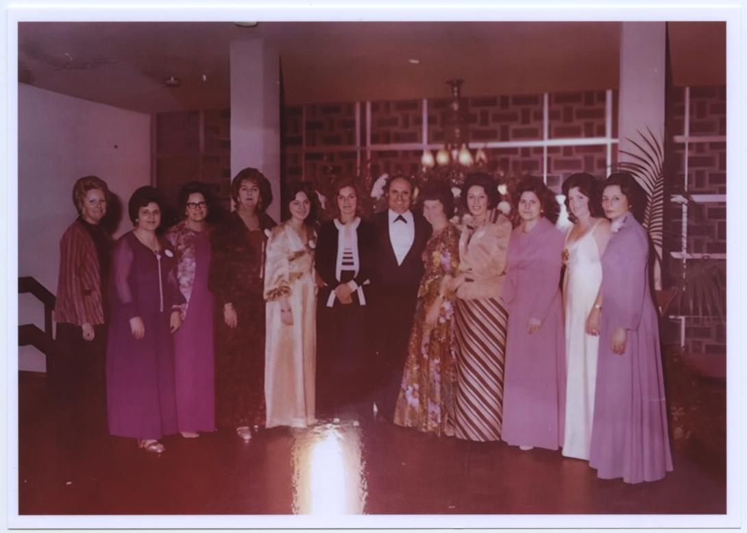 Group of 12 people pictured together in formal wear