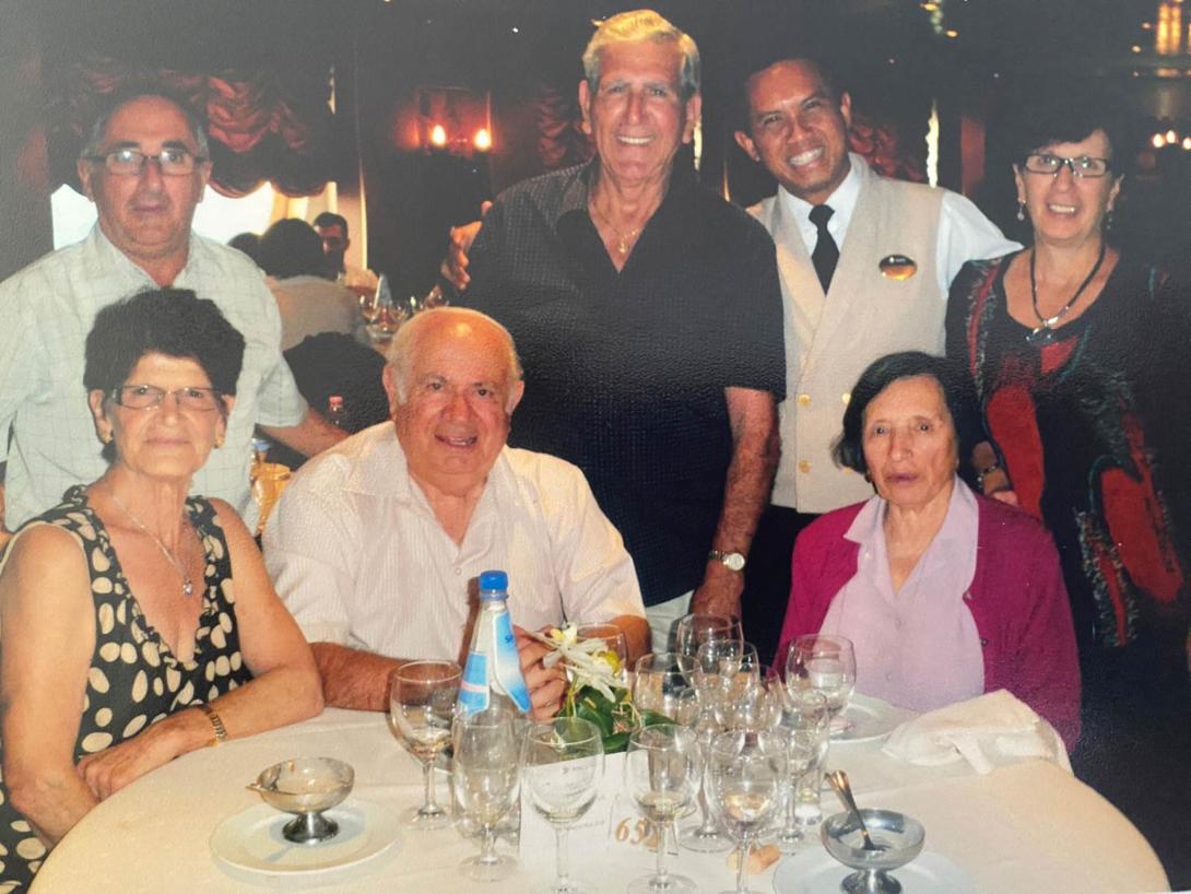 A happy group at a table with many wine glasses.