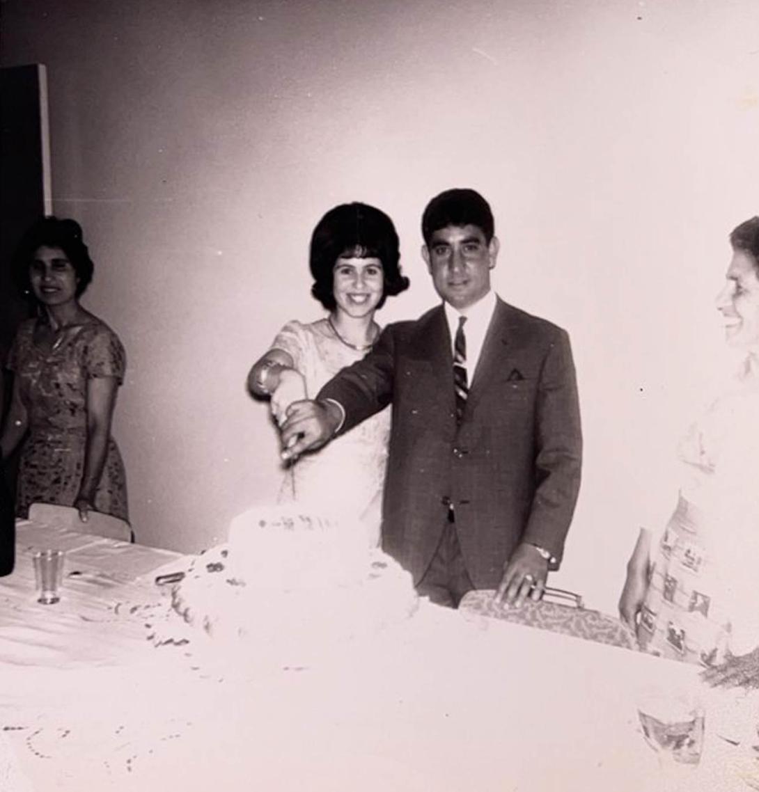 A beaming Carmela holds whe knife with Santo.