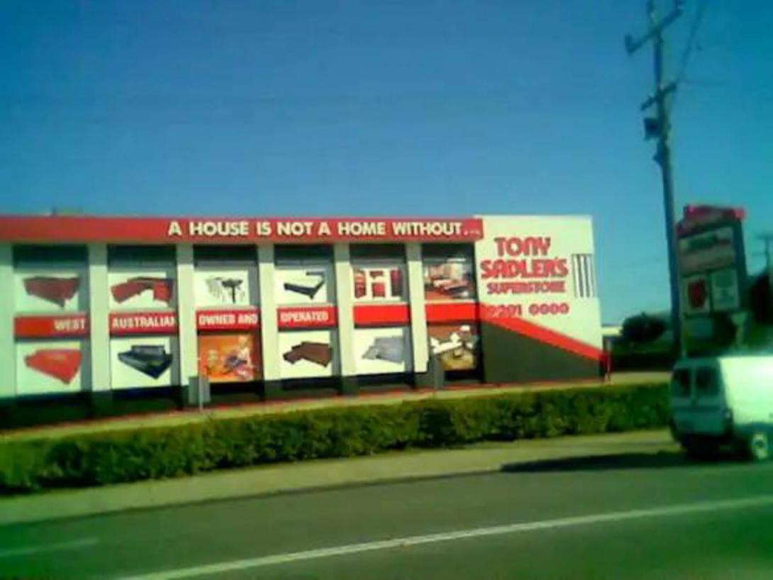 The store's sign reads "A house is not a home without Tony Sadler's Superstore."