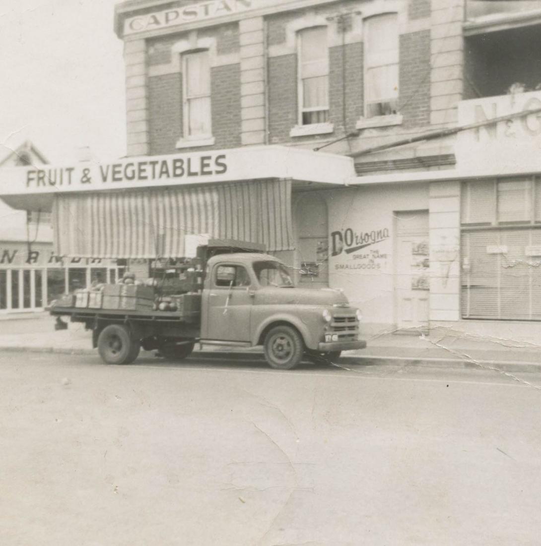 A truck piled high with goods outside the store.