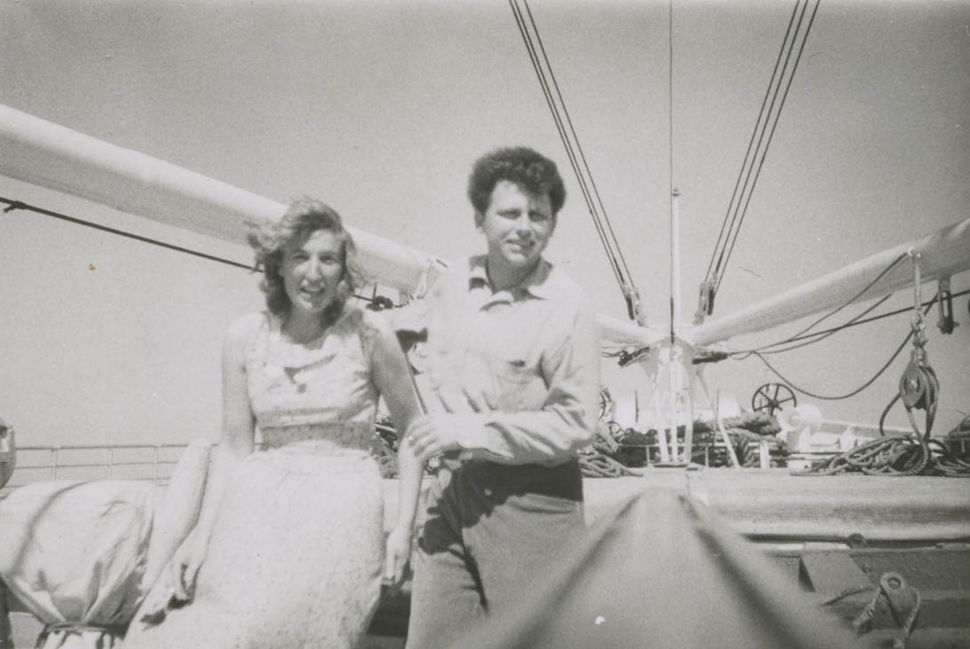 The couple having an adventure beneath the masts of a sailing ship.