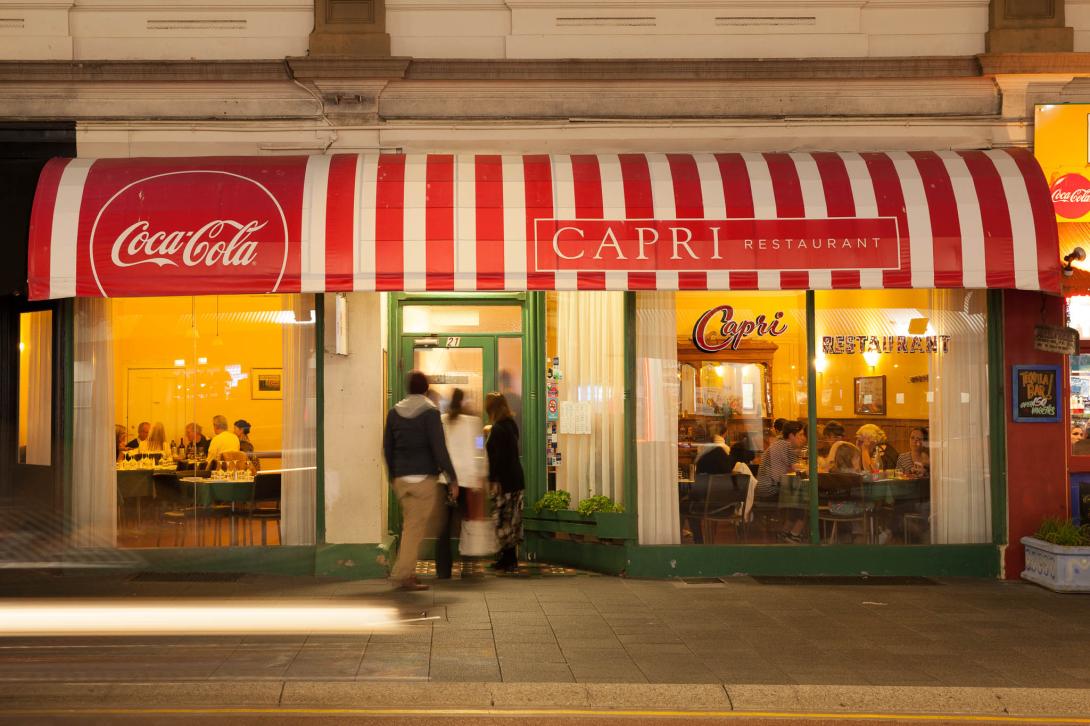 Patrons enter the brightly lit and attractive restaurant.