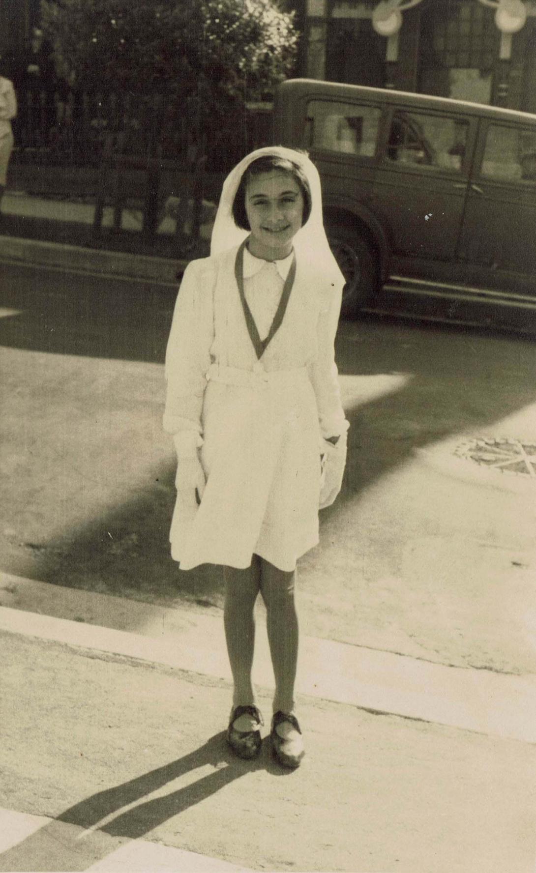Mary in a white dress and veil.