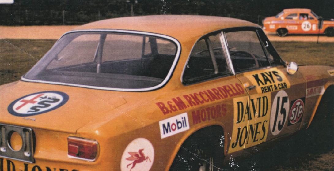 The bright orange "B&M Ricciardello Motors" sedan is plastered with ads for David Jones, Mobil, Kays Rent-A-Car and other logos.