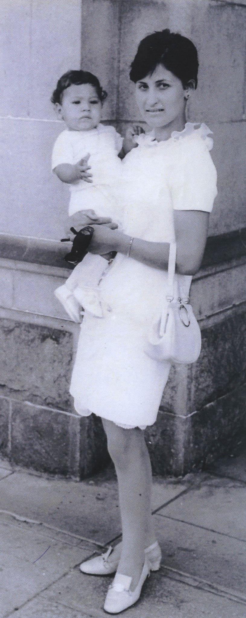 Rosie holding a small baby.