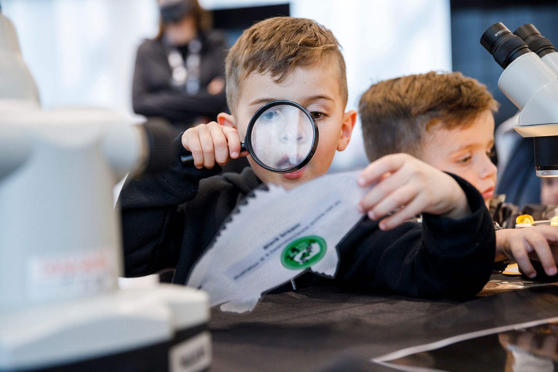Child looking through a microscope