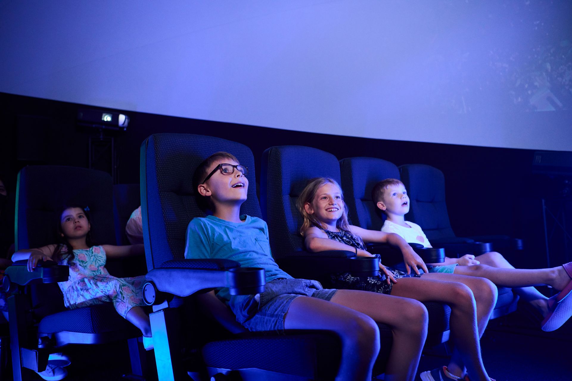 children sitting in theatre seats