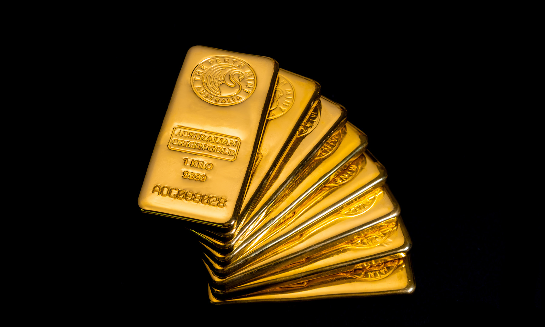 A stack of nine one kilogram cast gold bars fanned out