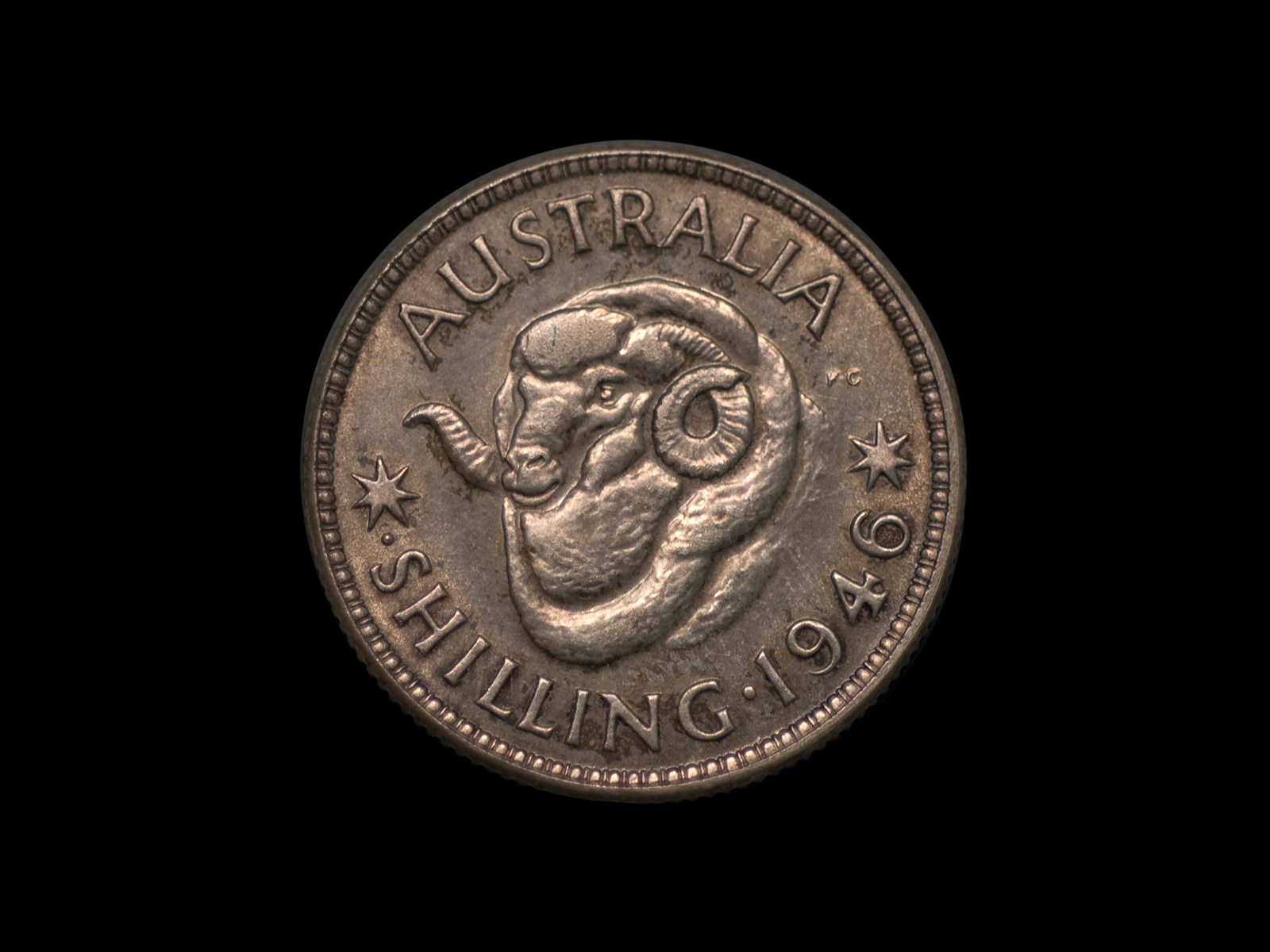 Silver coin 'AUSTRALIA SHILLING 1946' with central design of merino ram's head