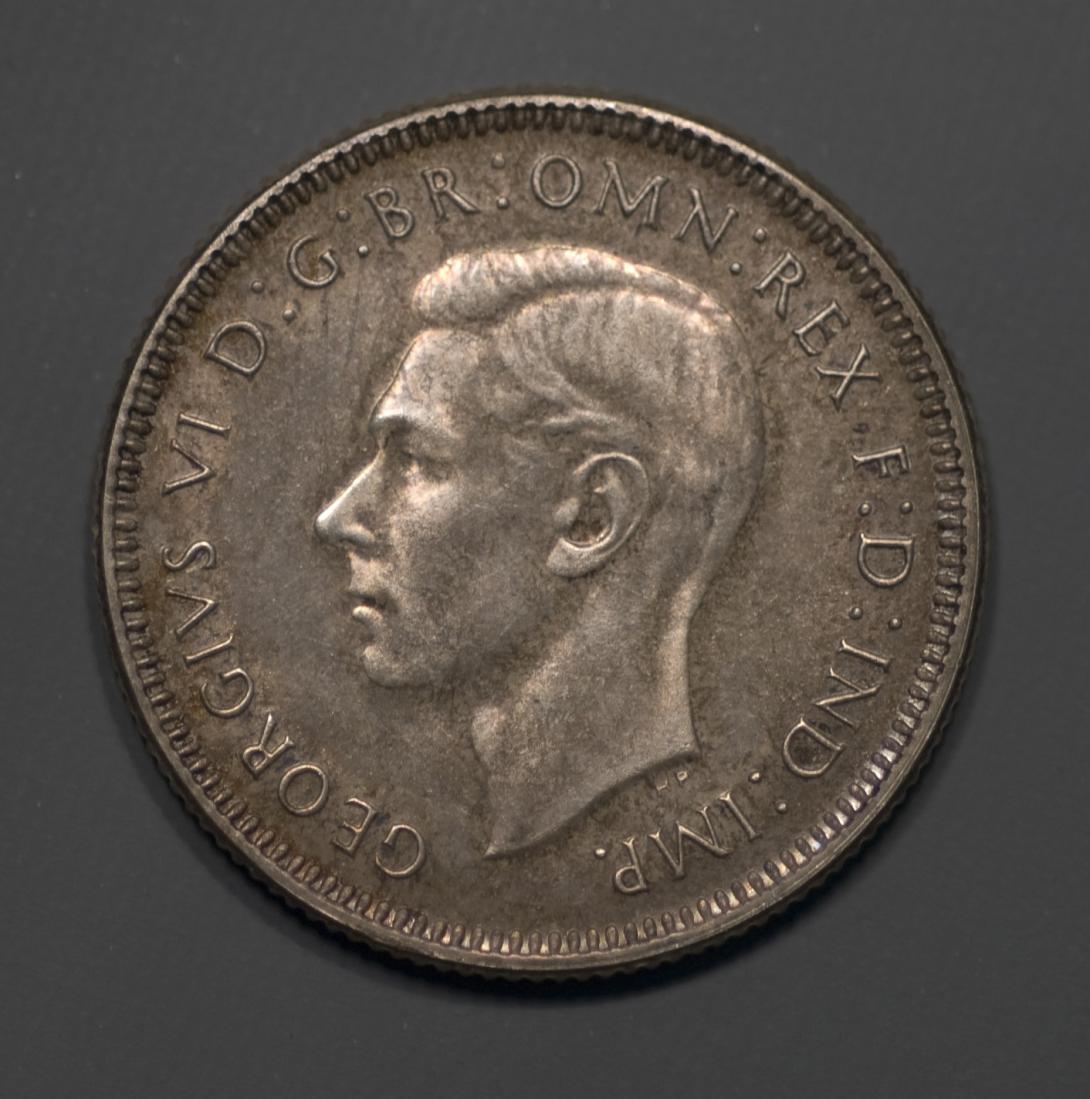 Obverse of silver coin 'GEORGIVS D : G : BR : OMN : REX F : D : IND : IMP.' with central bust of King George V.
