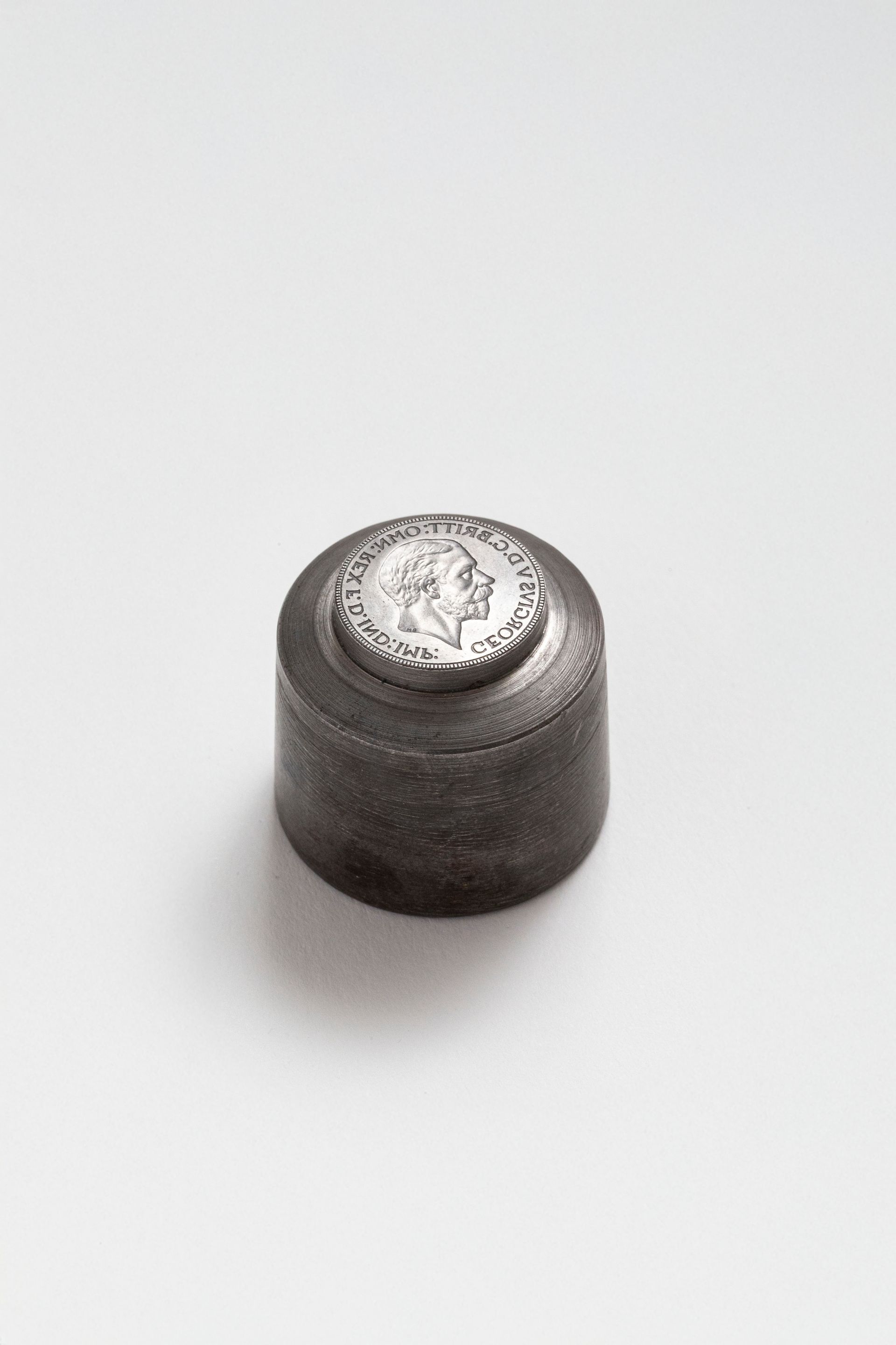Cylindrical metal obverse coin die featuring the effigy of King George V