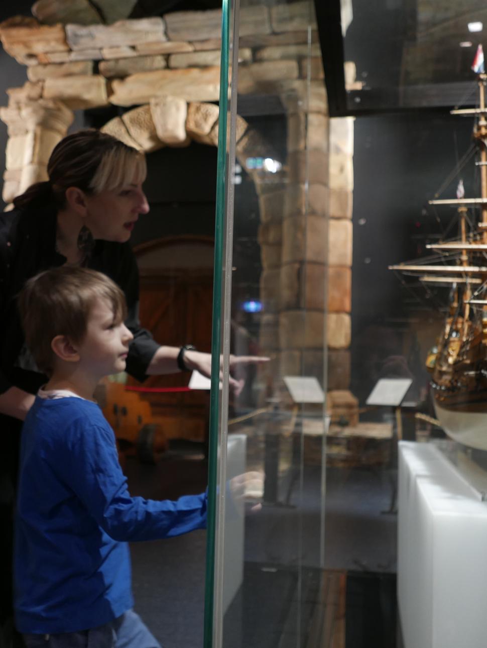 Person out a model ship to a child
