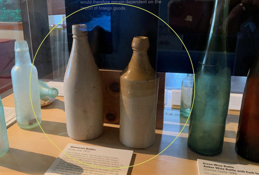 2 stoneware bottles displayed side by side