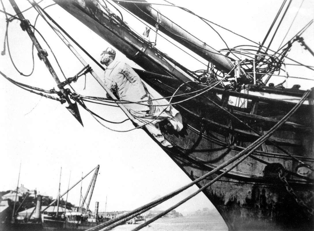 View of the figurehead mounted on a ship in port.