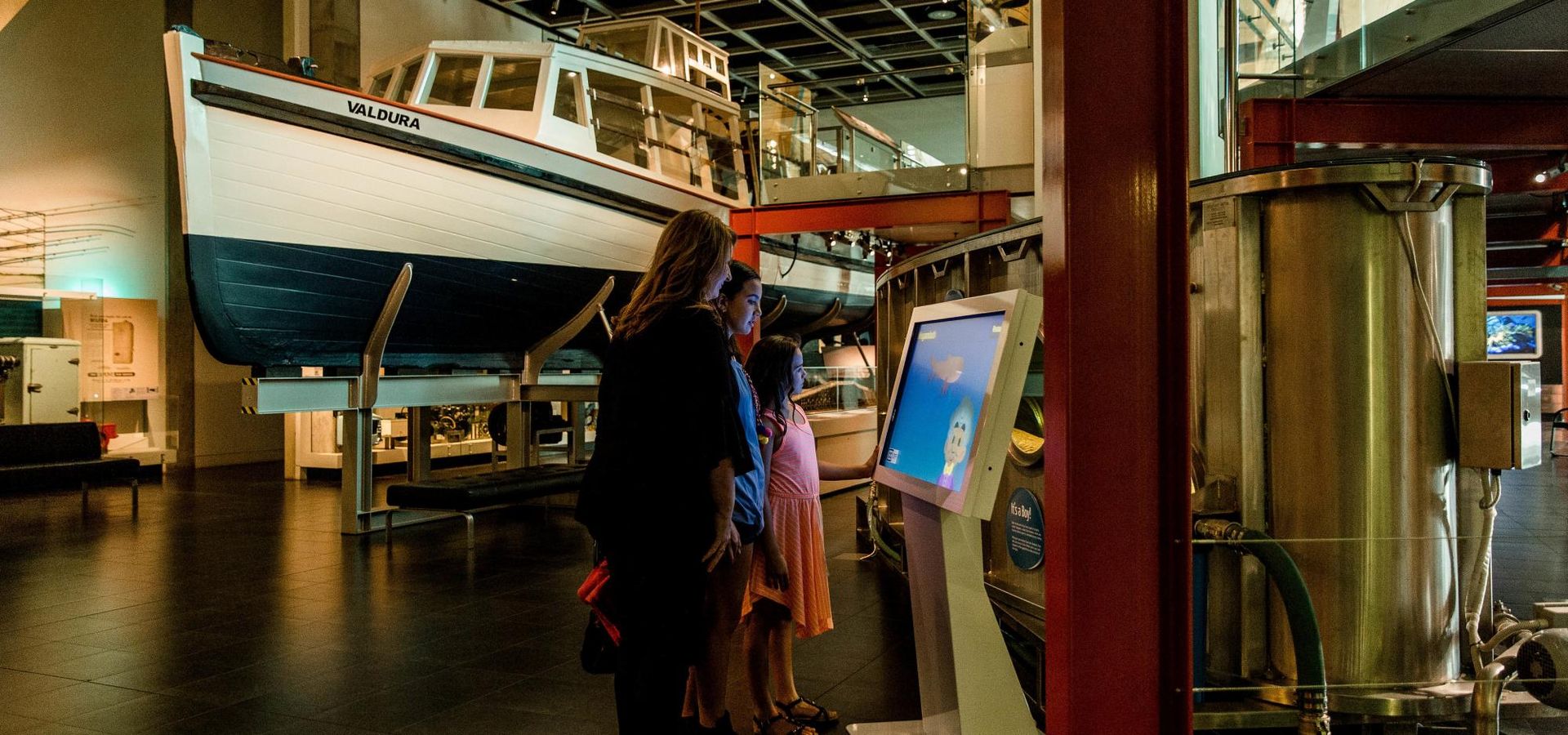 In the centre of the Museum ground floor is a walkway surrounded by boats suspended in the air.