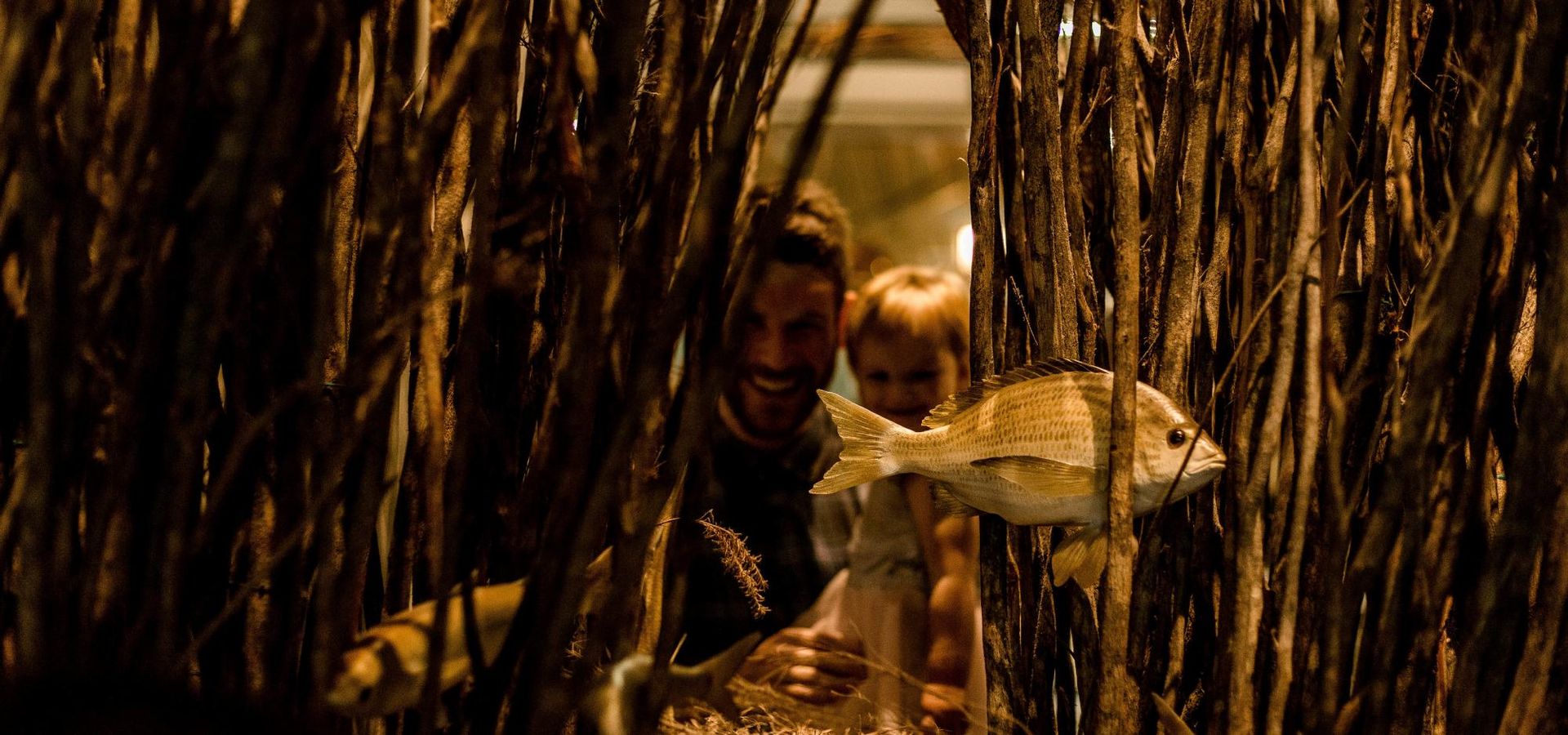 An aboriginal fish trap made up of long sticks bundled vertically marks the beginning of the gallery.