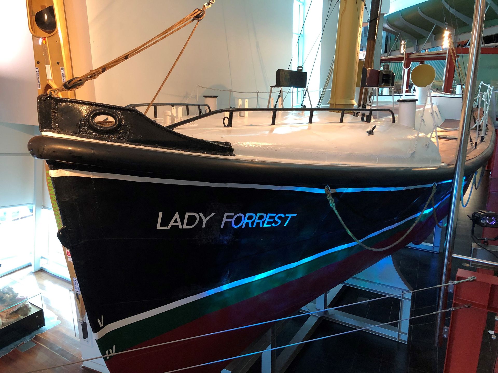 The red and black hull of the Lady Forrest is suspended next to the walkway.
