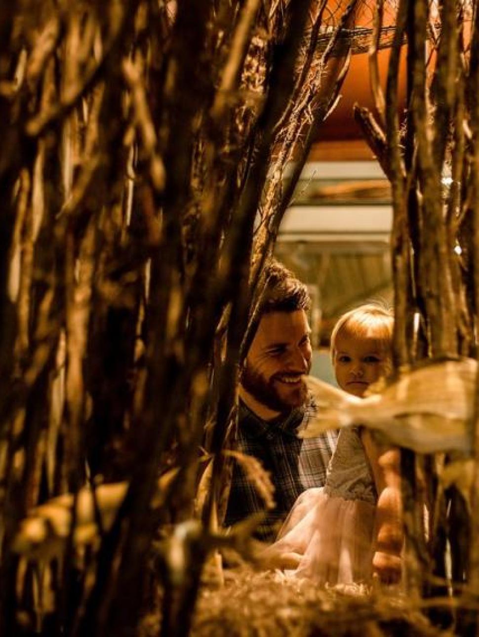 Man and child looking at a museum exhibition
