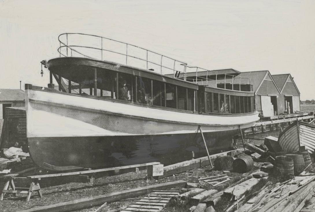 A ferry under construction, its cabin is more rounded and further forward than the Valdura, and there is a passenger railing on the top extending across the whole of the boat.