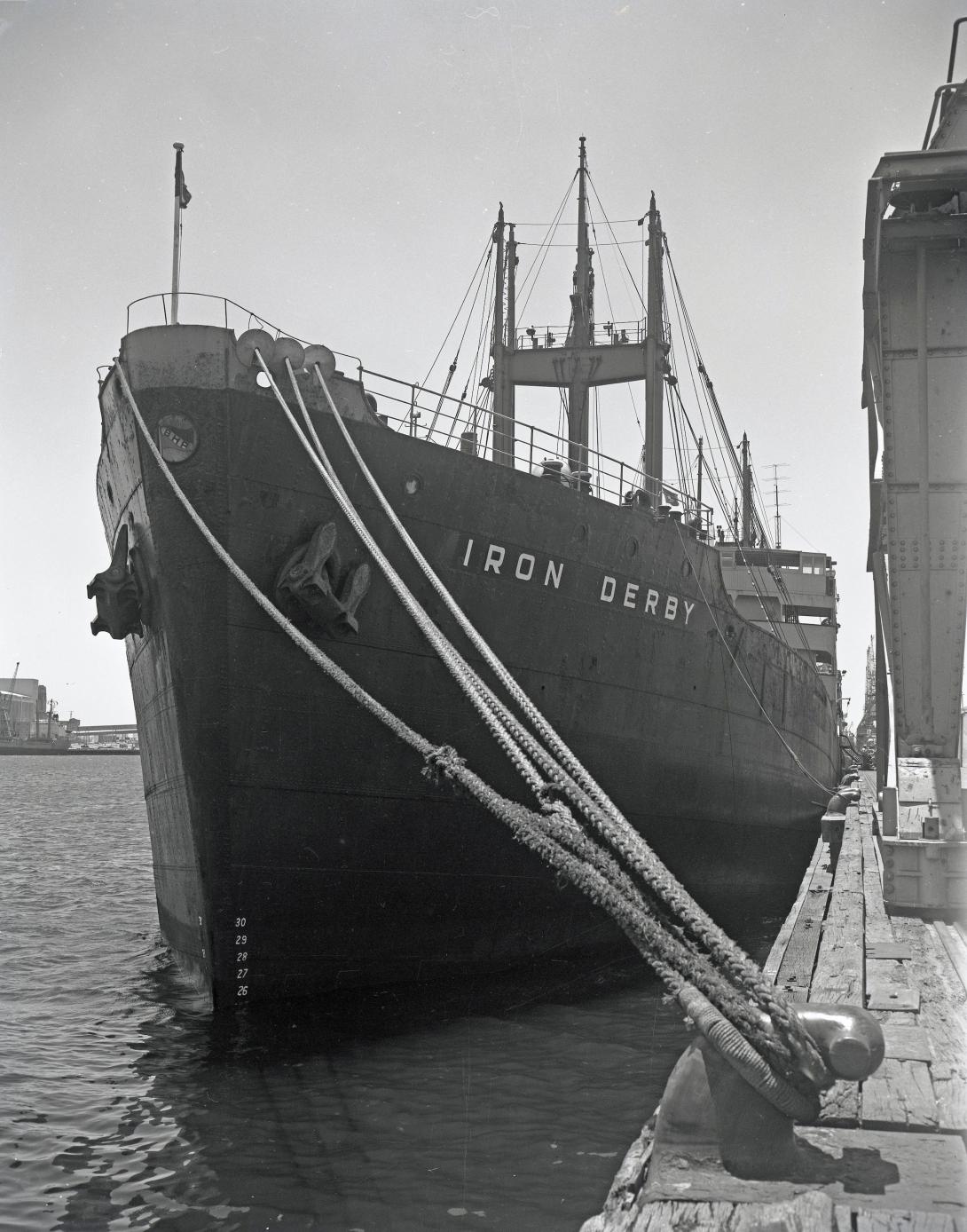 Ship, Iron Derby, moored at the quay, with many ropes securing it to the bollard.
